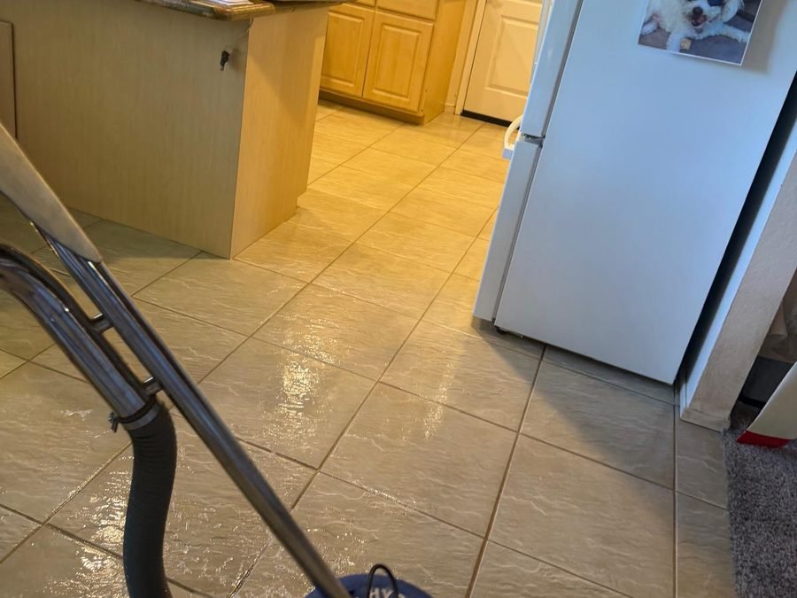 Pressure washing a concrete driveway, half clean half dirty (900×700)