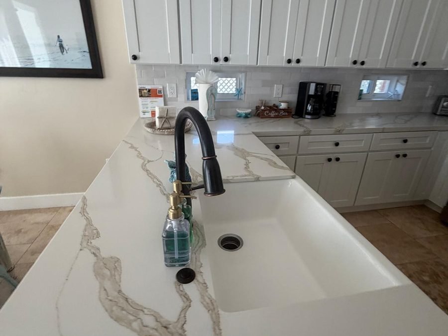Housekeeper wiping a kitchen counter in a bright SLO home (900×700)